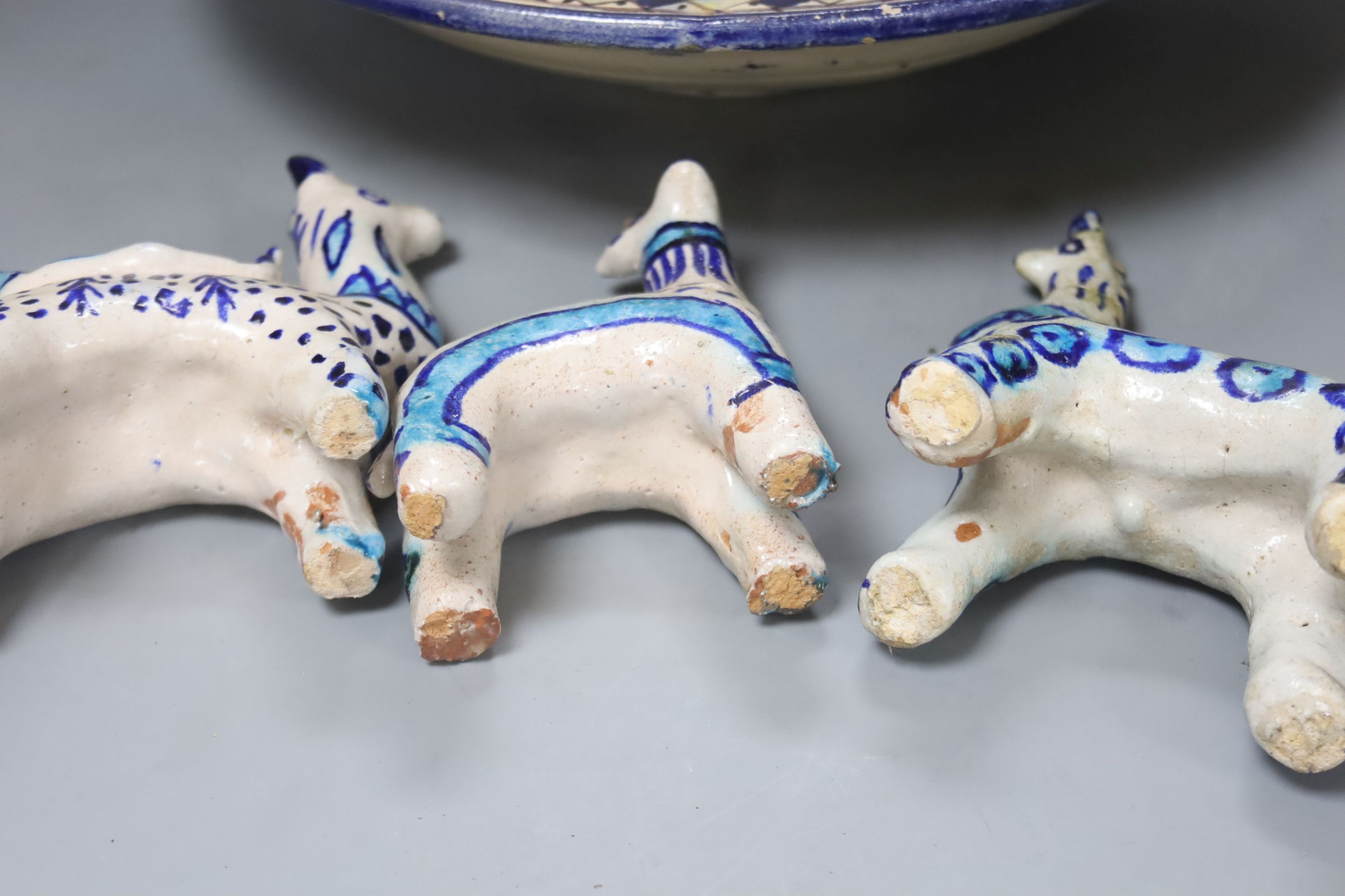 A Moroccan pottery dish, diameter 36cm, and three fritware animal figures